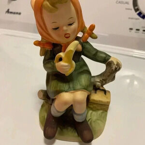 Girl Designed Figure Eatting a Banana on a Tree Stump